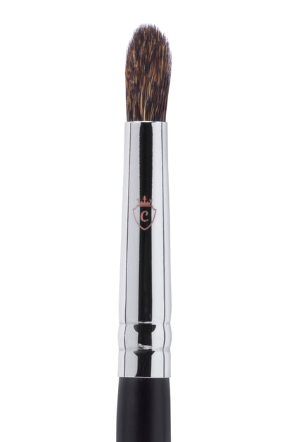 Single makeup brush with brown bristles, a silver metal ferrule, and a black handle featuring a small crest logo.