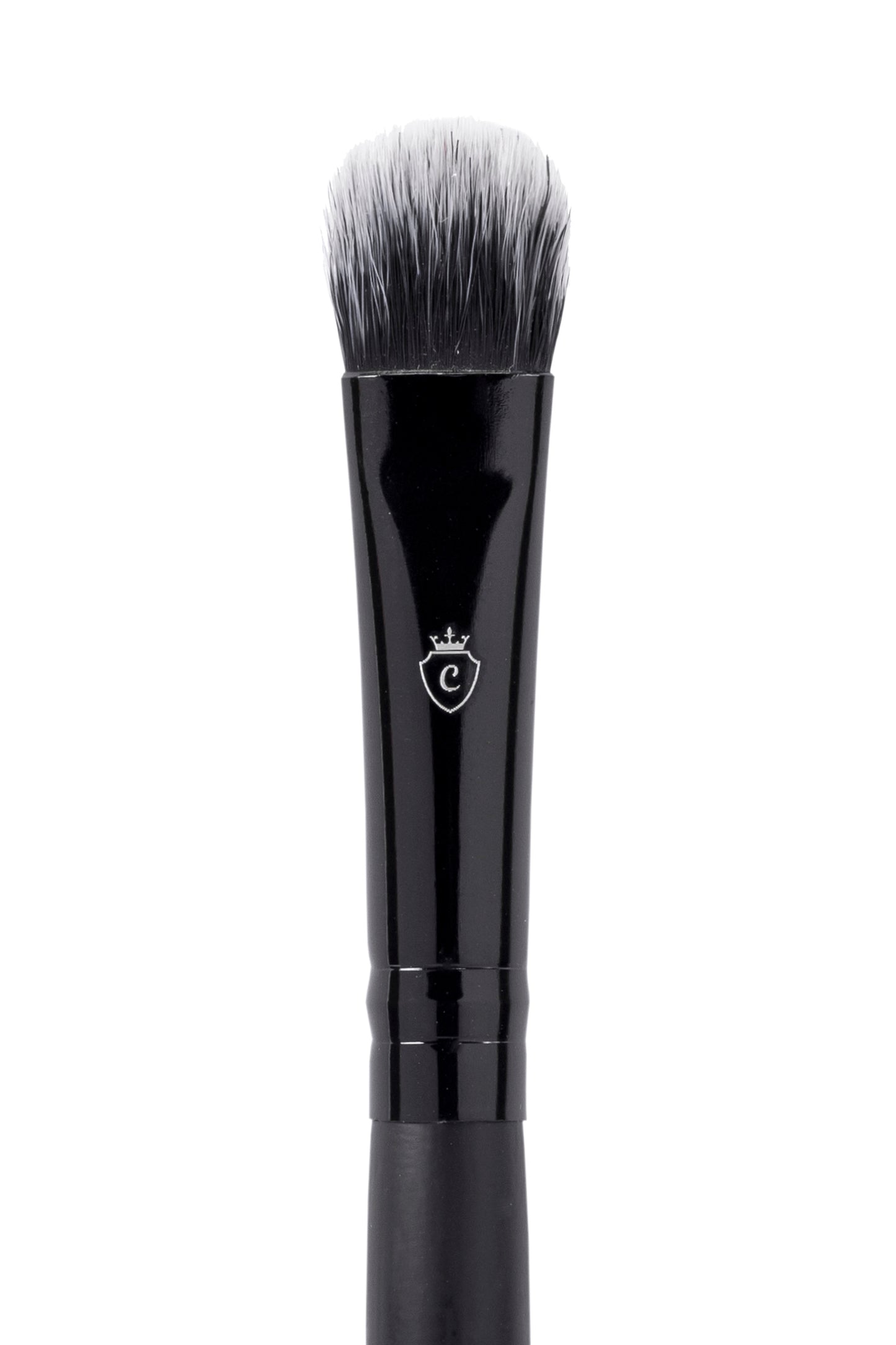 Black makeup brush with a flat, rounded head, white-tipped bristles, and a silver crest logo on the handle.