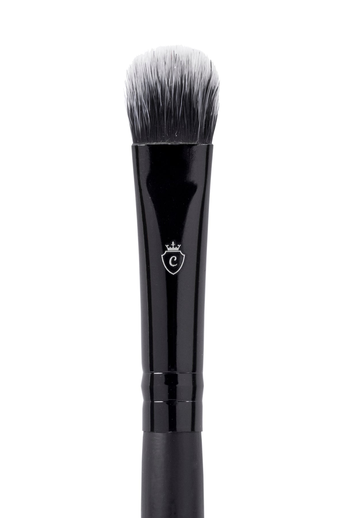Black makeup brush with a flat, rounded head, white-tipped bristles, and a silver crest logo on the handle.