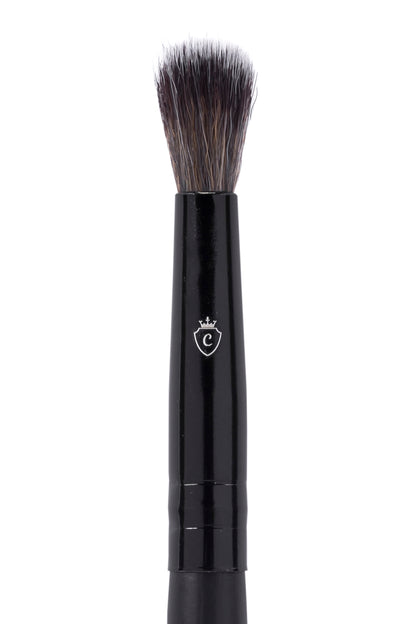 One black makeup brush with a silver C logo on the handle and soft, tapered bristles.